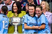 3 August 2025; Dublin players Leah Caffrey, left, and Martha Byrne prepare to lift the Brendan Martin cup after their side's victory in the TG4 All-Ireland Ladies Football Senior Championship final match between Dublin and Meath at Croke Park in Dublin. Photo by Seb Daly/Sportsfile