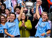 3 August 2025; Dublin players Leah Caffrey, left, and Martha Byrne lift the Brendan Martin cup after their side's victory in the TG4 All-Ireland Ladies Football Senior Championship final match between Dublin and Meath at Croke Park in Dublin. Photo by Seb Daly/Sportsfile