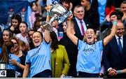 3 August 2025; Dublin players Laura Grendon, left, and Clodagh Fox lift the Brendan Martin cup after their side's victory in the TG4 All-Ireland Ladies Football Senior Championship final match between Dublin and Meath at Croke Park in Dublin. Photo by Seb Daly/Sportsfile