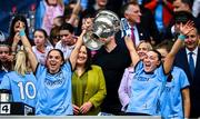 3 August 2025; Dublin players Niamh Crowley, left, and Niamh Donlon lift the Brendan Martin cup after their side's victory in the TG4 All-Ireland Ladies Football Senior Championship final match between Dublin and Meath at Croke Park in Dublin. Photo by Seb Daly/Sportsfile
