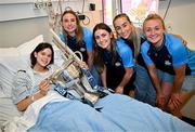 4 August 2025; TG4 All-Ireland Ladies Senior Football Champions and Dublin footballers Hannah Leahy, Aoife Kane, Aoife Curran and Carla Rowe pictured with the Brendan Martin Cup and Molly McEntaggart, aged 15, from Naas, Kildare, during a visit by the players to Children's Health Ireland at Crumlin, Dublin. Photo by Sam Barnes/Sportsfile