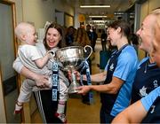 4 August 2025; TG4 All-Ireland Ladies Senior Football Champions and Dublin footballers Orlagh Nolan and Carla Rowe pictured with the Brendan Martin Cup and Saoirse Fearon, aged 4, from Kells, Meath and her mother Laura Fearon, during a visit by the players to Children's Health Ireland at Crumlin, Dublin. Photo by Sam Barnes/Sportsfile