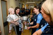 4 August 2025; TG4 All-Ireland Ladies Senior Football Champions and Dublin footballers Orlagh Nolan and Carla Rowe pictured with the Brendan Martin Cup and Saoirse Fearon, aged 4, from Kells, Meath and her mother Laura Fearon, during a visit by the players to Children's Health Ireland at Crumlin, Dublin. Photo by Sam Barnes/Sportsfile