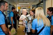 4 August 2025; TG4 All-Ireland Ladies Senior Football Champions Dublin pictured with the Brendan Martin Cup and Saoirse Fearon, aged 4, from Kells, Meath, and her mother Laura Fearon, during a visit by the players to Children's Health Ireland at Crumlin, Dublin. Photo by Sam Barnes/Sportsfile