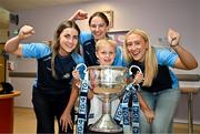 4 August 2025; TG4 All-Ireland Ladies Senior Football Champions and Dublin footballers Aoife Kane, Orlagh Nolan and Jodi Egan pictured the Brendan Martin Cup and Nate Briggs, aged 8, from Dublin, during a visit by the players to Children's Health Ireland at Crumlin, Dublin. Photo by Sam Barnes/Sportsfile
