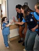 4 August 2025; TG4 All-Ireland Ladies Senior Football Champions, Dublin footballers Rachel Hartnett and Hannah Leahy pictured with Nikki Hayes, aged 16, from Limerick, during a visit by the players to Children's Health Ireland at Crumlin, Dublin. Photo by Sam Barnes/Sportsfile