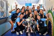 4 August 2025; TG4 All-Ireland Ladies Senior Football Champions Dublin pictured with the Brendan Martin Cup and Zoe Moore, aged 9, from Ballinteer Dublin, neice of Joint manager Derek Murray, during a visit by the players to Children's Health Ireland at Crumlin, Dublin. Photo by Sam Barnes/Sportsfile