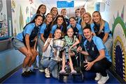4 August 2025; TG4 All-Ireland Ladies Senior Football Champions Dublin pictured with the Brendan Martin Cup and Zoe Moore, aged 9, from Ballinteer Dublin, neice of Joint manager Derek Murray, and her mother Carol, during a visit by the players to Children's Health Ireland at Crumlin, Dublin. Photo by Sam Barnes/Sportsfile