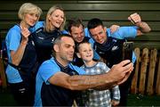 4 August 2025; TG4 All-Ireland Ladies Senior Football Champions Dublin support staff including joint managers Paul Casey, centre, and Derek Murray, far right pictured with Shane Comford, aged 7 from Lucan, during a visit by the players to Children's Health Ireland at Crumlin, Dublin. Photo by Sam Barnes/Sportsfile