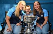 4 August 2025; TG4 All-Ireland Ladies Senior Football Champions Dublin footballers Jodi Egan and Hannah Leahy pictured with the Brendan Martin Cup and Shane Comford, aged 7, from Lucan in Dublin, during a visit by the players to Children's Health Ireland at Crumlin, Dublin. Photo by Sam Barnes/Sportsfile