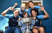 4 August 2025; TG4 All-Ireland Ladies Senior Football Champions Dublin footballers Orlagh Nolan, Carla Rowe, Leah Caffrey and Rachel Hartnett pictured with the Brendan Martin Cup and Katie Brennan, aged 11, from Navan in Meath, during a visit by the players to Children's Health Ireland at Crumlin, Dublin. Photo by Sam Barnes/Sportsfile