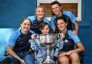 4 August 2025; TG4 All-Ireland Ladies Senior Football Champions Dublin footballers Orlagh Nolan, Carla Rowe, Leah Caffrey and Rachel Hartnett pictured with the Brendan Martin Cup and Katie Brennan, aged 11, from Navan in Meath, during a visit by the players to Children's Health Ireland at Crumlin, Dublin. Photo by Sam Barnes/Sportsfile