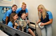 4 August 2025; TG4 All-Ireland Ladies Senior Football Champions Dublin footballers Aoife Kane, Orlagh Nolan, Carla Rowe and Jodi Egan pictured with the Brendan Martin Cup and Zoe Moore, aged 9, from Ballinteer Dublin, neice of Joint manager Derek Murray, during a visit by the players to Children's Health Ireland at Crumlin, Dublin. Photo by Sam Barnes/Sportsfile