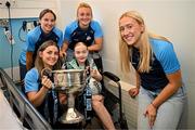 4 August 2025; TG4 All-Ireland Ladies Senior Football Champions Dublin footballers Aoife Kane, Orlagh Nolan, Carla Rowe and Jodi Egan pictured with the Brendan Martin Cup and Zoe Moore, aged 9, from Ballinteer Dublin, neice of Joint manager Derek Murray, during a visit by the players to Children's Health Ireland at Crumlin, Dublin. Photo by Sam Barnes/Sportsfile