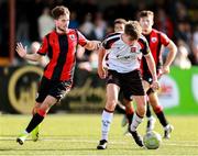 4 August 2025; Eoin Kenny of Dundalk in action against Daniel Norris of Longford Town during the SSE Airtricity Men's First Division match between Dundalk and Longford Town at Oriel Park in Dundalk, Louth. Photo by Thomas Flinkow/Sportsfile