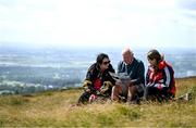 4 August 2025; Spectators, from left, Tanya, Patsy and Kate Murphy inspect the event programme during the M. Donnelly GAA Poc Fada All-Ireland Finals at Annaverna Mountain in the Cooley Peninsula, Ravensdale, Louth. Photo by Shauna Clinton/Sportsfile