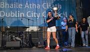 5 August 2025; Leah Caffrey with The Brendan Martin Cup during the homecoming of TG4 All-Ireland Ladies Senior Football Champions, Dublin, at Smithfield Square in Dublin. Photo by Sam Barnes/Sportsfile