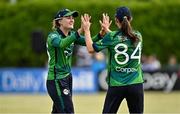 6 August 2025; Gaby Lewis of Ireland, left, celebrates with teammate Orla Prendergast after catching out Rameen Shamim of Pakistan during match one of the Women's T20 International Series between Ireland and Pakistan at Clontarf Cricket Club in Dublin. Photo by Sam Barnes/Sportsfile