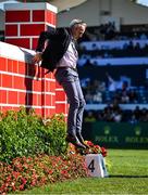 9 August 2025; Former jockey Ruby Walsh jumps off the Puissance Wall during the Dublin Horse Show at the RDS Arena in Dublin. Photo by Shauna Clinton/Sportsfile