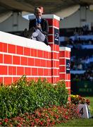 9 August 2025; Former jockey Ruby Walsh sits on the Puissance Wall during the Dublin Horse Show at the RDS Arena in Dublin. Photo by Shauna Clinton/Sportsfile