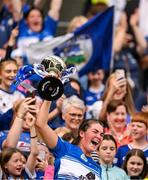 10 August 2025; Laois captain Clodagh Tynan lifts The Kathleen Mills Cup after her side's victory in the Glen Dimplex All-Ireland Premier Junior Camogie Championship final match between Armagh and Laois at Croke Park in Dublin. Photo by Ramsey Cardy/Sportsfile