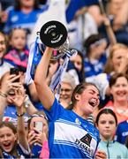 10 August 2025; Laois captain Clodagh Tynan lifts The Kathleen Mills Cup after her side's victory in the Glen Dimplex All-Ireland Premier Junior Camogie Championship final match between Armagh and Laois at Croke Park in Dublin. Photo by Ramsey Cardy/Sportsfile