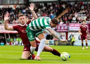 10 August 2025; Lee Grace of Shamrock Rovers is tackled by Axel Piesold of Galway United during the SSE Airtricity Men's Premier Division match between Galway United and Shamrock Rovers at Eamonn Deacy Park in Galway. Photo by Thomas Flinkow/Sportsfile