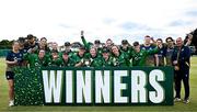 10 August 2025; Ireland players and coaches celebrate with the trophy after their side's victory in match three of the Women's T20 International Series between Ireland and Pakistan at Castle Avenue Cricket Ground in Dublin. Photo by Seb Daly/Sportsfile