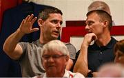 12 August 2025; Dublin gaelic footballer Stephen Cluxton, left, in conversation with Shelbourne chief executive officer Tomás Quinn during the UEFA Europa League Third Qualifying Round 2nd Leg match between Shelbourne and Rijeka at Tolka Park in Dublin. Photo by Ben McShane/Sportsfile