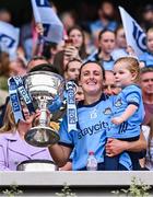 3 August 2025; Dublin footballer Hannah Tyrrell lifts the Brendan Martin Cup with her daughter Aoife, age 2, after the TG4 All-Ireland Ladies Football Senior Championship final match between Dublin and Meath at Croke Park in Dublin. Photo by Piaras Ó Mídheach/Sportsfile