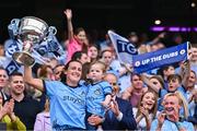 3 August 2025; Dublin footballer Hannah Tyrrell lifts the Brendan Martin Cup with her daughter Aoife, age 2, after the TG4 All-Ireland Ladies Football Senior Championship final match between Dublin and Meath at Croke Park in Dublin. Photo by Piaras Ó Mídheach/Sportsfile
