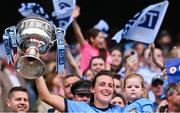 3 August 2025; Dublin footballer Hannah Tyrrell lifts the Brendan Martin Cup with her daughter Aoife, age 2, after the TG4 All-Ireland Ladies Football Senior Championship final match between Dublin and Meath at Croke Park in Dublin. Photo by Piaras Ó Mídheach/Sportsfile
