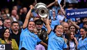 3 August 2025; Dublin players Annabelle Timothy, left, and Aoife Curran of Dublin lift the Brendan Martin Cup after the TG4 All-Ireland Ladies Football Senior Championship final match between Dublin and Meath at Croke Park in Dublin. Photo by Piaras Ó Mídheach/Sportsfile