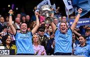 3 August 2025; Dublin players Ashling Nyhan, left, and Hannah McGinnis lift the Brendan Martin Cup after the TG4 All-Ireland Ladies Football Senior Championship final match between Dublin and Meath at Croke Park in Dublin. Photo by Piaras Ó Mídheach/Sportsfile