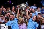 3 August 2025; Dublin players Sophie McIntyre, left, and Siobhán Birnie of Dublin lift the Brendan Martin Cup after the TG4 All-Ireland Ladies Football Senior Championship final match between Dublin and Meath at Croke Park in Dublin. Photo by Piaras Ó Mídheach/Sportsfile