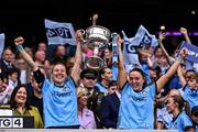 3 August 2025; Dublin players Nicole Owens, left, and Sinéad Goldrick lift the Brendan Martin Cup after the TG4 All-Ireland Ladies Football Senior Championship final match between Dublin and Meath at Croke Park in Dublin. Photo by Piaras Ó Mídheach/Sportsfile
