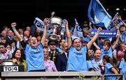3 August 2025; Dublin players Nicole Owens, left, and Sinéad Goldrick lift the Brendan Martin Cup after the TG4 All-Ireland Ladies Football Senior Championship final match between Dublin and Meath at Croke Park in Dublin. Photo by Piaras Ó Mídheach/Sportsfile