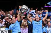 3 August 2025; Dublin players Laura Grendon, left, and Clodagh Fox lift the Brendan Martin Cup after the TG4 All-Ireland Ladies Football Senior Championship final match between Dublin and Meath at Croke Park in Dublin. Photo by Piaras Ó Mídheach/Sportsfile