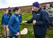 4 August 2025; Camogie Association president Brian Molloy presents a sliotar to Siofra Ginty of Offaly before the U16 camogie competition at the M. Donnelly GAA Poc Fada All-Ireland Finals at Annaverna Mountain in the Cooley Peninsula, Ravensdale, Louth. Photo by Piaras Ó Mídheach/Sportsfile