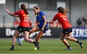 16 August 2025; Sophia White of Leinster kicks on despite the efforts of Munster players Lily Byrne, left, and Lisa O'Mahony during the PwC U-18 Girls Interprovincial Series match between Leinster and Munster at Energia Park in Dublin. Photo by Shauna Clinton/Sportsfile