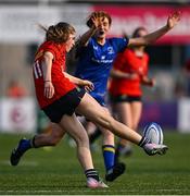 16 August 2025; Orlagh O'Brien of Leinster blocks the kick of Keelin O'Shea of Munster during the PwC U-18 Girls Interprovincial Series match between Leinster and Munster at Energia Park in Dublin. Photo by Shauna Clinton/Sportsfile