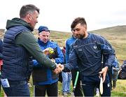 4 August 2025; GAA National Head of Hurling Willie Maher presents a sliotar to Colin Ryan of Limerick before the M. Donnelly GAA Poc Fada All-Ireland Finals at Annaverna Mountain in the Cooley Peninsula, Ravensdale, Louth. Photo by Piaras Ó Mídheach/Sportsfile
