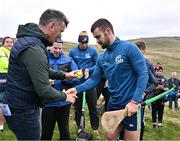 4 August 2025; GAA National Head of Hurling Willie Maher presents a sliotar to Bobby Douglas of Mayo before the M. Donnelly GAA Poc Fada All-Ireland Finals at Annaverna Mountain in the Cooley Peninsula, Ravensdale, Louth. Photo by Piaras Ó Mídheach/Sportsfile