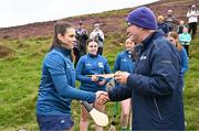 4 August 2025; Camogie President Brian Molloy presents a sliotar to Molly Lynch of Cork before the M. Donnelly GAA Poc Fada All-Ireland Finals at Annaverna Mountain in the Cooley Peninsula, Ravensdale, Louth. Photo by Piaras Ó Mídheach/Sportsfile