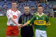 26 September 2004; Tyrone minor captain Marc Cunningham shakes hands with Kerry minor captain Shane Murphy in the presence of referee Tom Quigley. All-Ireland Minor Football Championship Final, Kerry v Tyrone, Croke Park, Dublin. Picture credit; Ray McManus / SPORTSFILE *** Local Caption *** Any photograph taken by SPORTSFILE during, or in connection with, the 2004 All-Ireland Minor Football Final which displays GAA logos or contains an image or part of an image of any GAA intellectual property, or, which contains images of a GAA player/players in their playing uniforms, may only be used for editorial and non-advertising purposes.  Use of photographs for advertising, as posters or for purchase separately is strictly prohibited unless prior written approval has been obtained from the Gaelic Athletic Association.