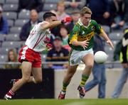 26 September 2004; Paul O'Connor, Kerry, in action against Niall McGinn, Tyrone. All-Ireland Minor Football Championship Final, Kerry v Tyrone, Croke Park, Dublin. Picture credit; Ray McManus / SPORTSFILE *** Local Caption *** Any photograph taken by SPORTSFILE during, or in connection with, the 2004 All-Ireland Minor Football Final which displays GAA logos or contains an image or part of an image of any GAA intellectual property, or, which contains images of a GAA player/players in their playing uniforms, may only be used for editorial and non-advertising purposes.  Use of photographs for advertising, as posters or for purchase separately is strictly prohibited unless prior written approval has been obtained from the Gaelic Athletic Association.