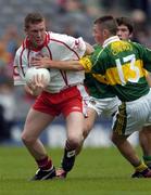 26 September 2004; Marc Cunningham, Tyrone, in action against Shane Murphy, Kerry. All-Ireland Minor Football Championship Final, Kerry v Tyrone, Croke Park, Dublin. Picture credit; Ray McManus / SPORTSFILE *** Local Caption *** Any photograph taken by SPORTSFILE during, or in connection with, the 2004 All-Ireland Minor Football Final which displays GAA logos or contains an image or part of an image of any GAA intellectual property, or, which contains images of a GAA player/players in their playing uniforms, may only be used for editorial and non-advertising purposes.  Use of photographs for advertising, as posters or for purchase separately is strictly prohibited unless prior written approval has been obtained from the Gaelic Athletic Association.