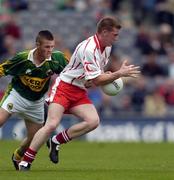26 September 2004; Marc Cunningham, Tyrone, in action against Shane Murphy, Kerry. All-Ireland Minor Football Championship Final, Kerry v Tyrone, Croke Park, Dublin. Picture credit; Ray McManus / SPORTSFILE *** Local Caption *** Any photograph taken by SPORTSFILE during, or in connection with, the 2004 All-Ireland Minor Football Final which displays GAA logos or contains an image or part of an image of any GAA intellectual property, or, which contains images of a GAA player/players in their playing uniforms, may only be used for editorial and non-advertising purposes.  Use of photographs for advertising, as posters or for purchase separately is strictly prohibited unless prior written approval has been obtained from the Gaelic Athletic Association.