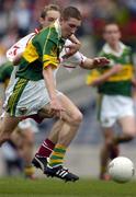 26 September 2004; Andrew Kennelly, Kerry, in action against John Gilmore, Tyrone. All-Ireland Minor Football Championship Final, Kerry v Tyrone, Croke Park, Dublin. Picture credit; Ray McManus / SPORTSFILE *** Local Caption *** Any photograph taken by SPORTSFILE during, or in connection with, the 2004 All-Ireland Minor Football Final which displays GAA logos or contains an image or part of an image of any GAA intellectual property, or, which contains images of a GAA player/players in their playing uniforms, may only be used for editorial and non-advertising purposes.  Use of photographs for advertising, as posters or for purchase separately is strictly prohibited unless prior written approval has been obtained from the Gaelic Athletic Association.