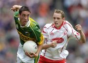 26 September 2004; Anthony Maher, Kerry, in action against John Gilmore, Tyrone. All-Ireland Minor Football Championship Final, Kerry v Tyrone, Croke Park, Dublin. Picture credit; Ray McManus / SPORTSFILE *** Local Caption *** Any photograph taken by SPORTSFILE during, or in connection with, the 2004 All-Ireland Minor Football Final which displays GAA logos or contains an image or part of an image of any GAA intellectual property, or, which contains images of a GAA player/players in their playing uniforms, may only be used for editorial and non-advertising purposes.  Use of photographs for advertising, as posters or for purchase separately is strictly prohibited unless prior written approval has been obtained from the Gaelic Athletic Association.